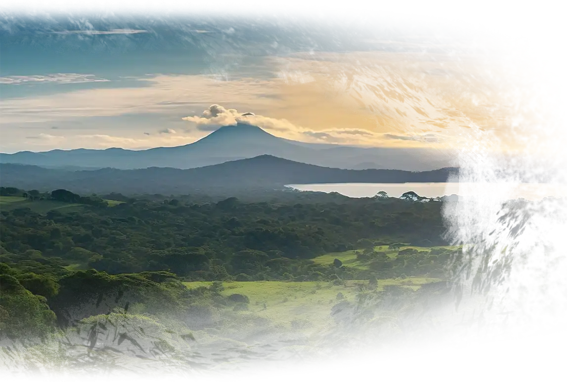 alt="Beautiful Arenal Volcano landscape with river and blue sky"